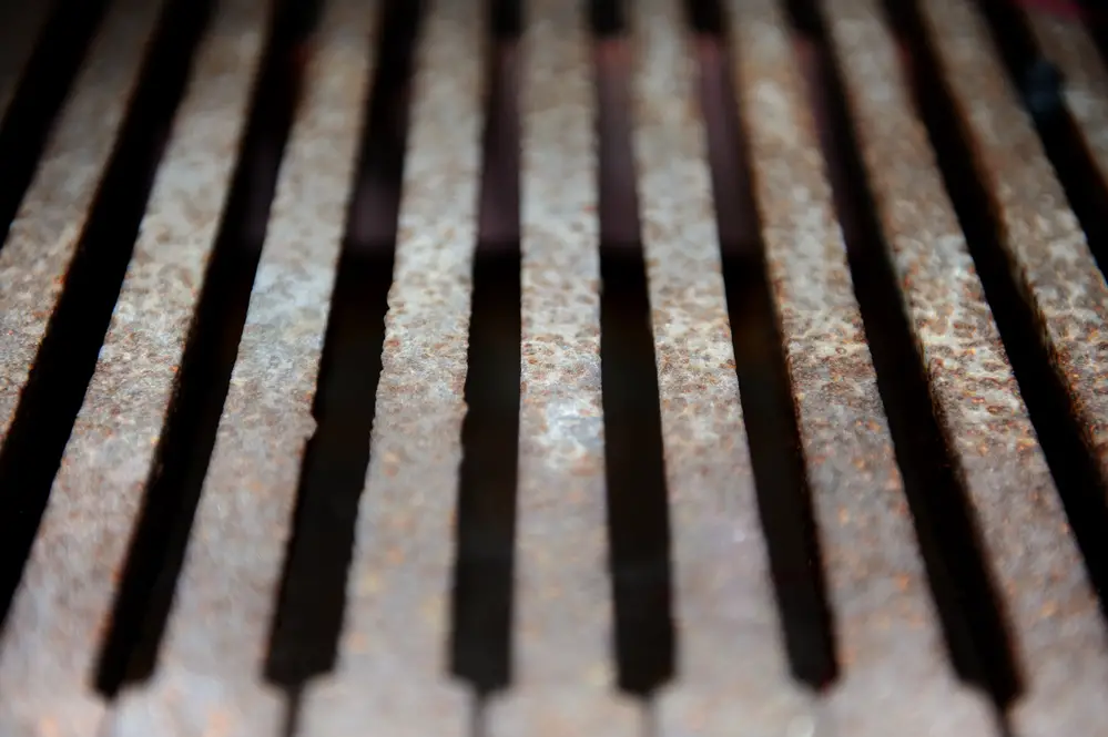 Rusty iron grate of barbecue grill